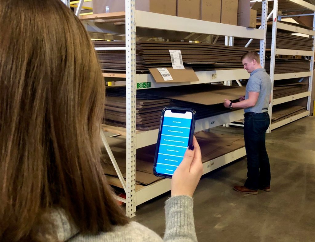 Man viewing inventory in warehouse
